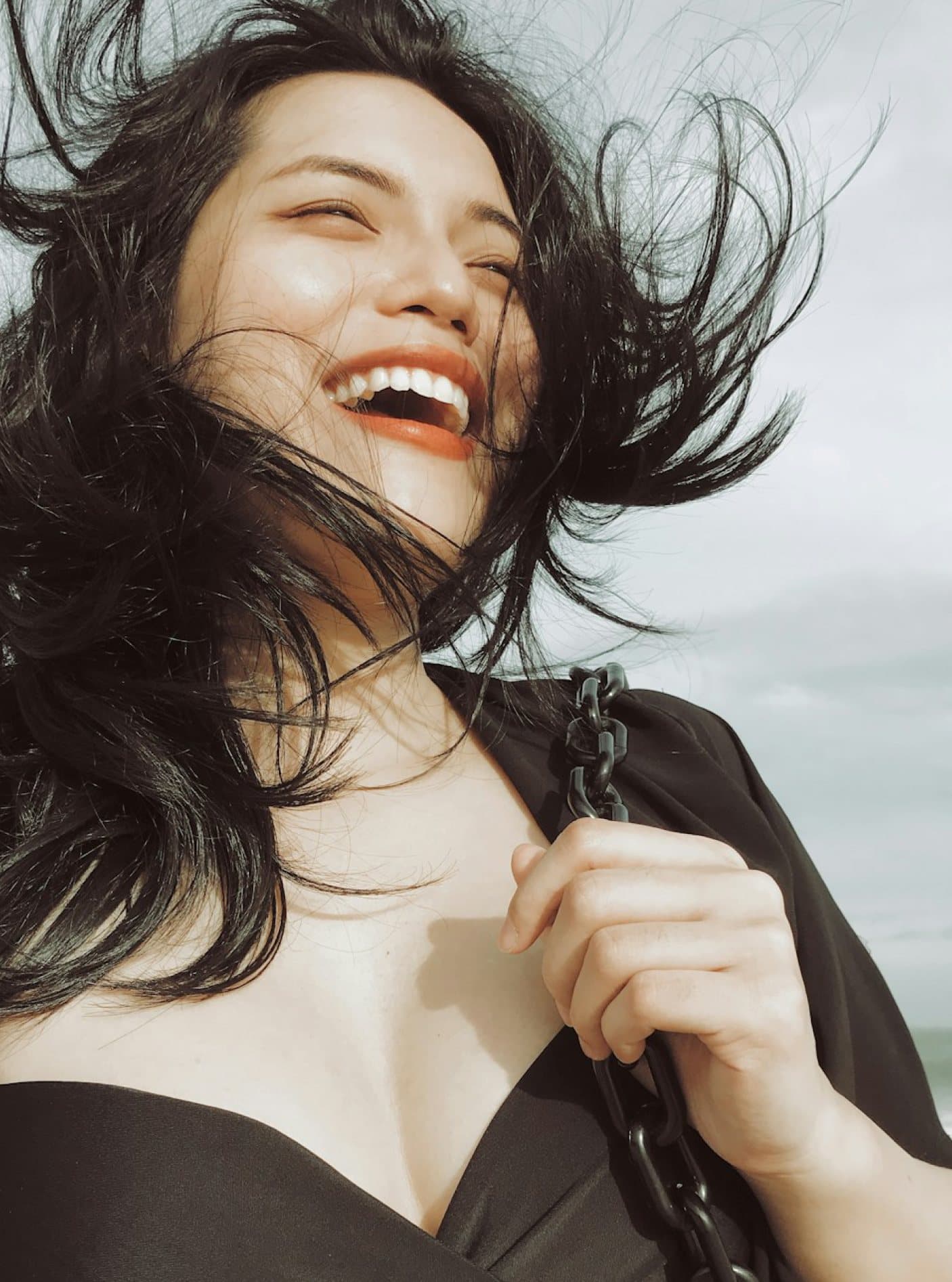 Woman laughing, lying down with her hair fanned out